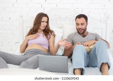 Man Watching His Wife Using Laptop Stock Photo Edit Now