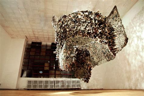A Sculpture Made Out Of Hundreds Of Objects In A Room With Wood