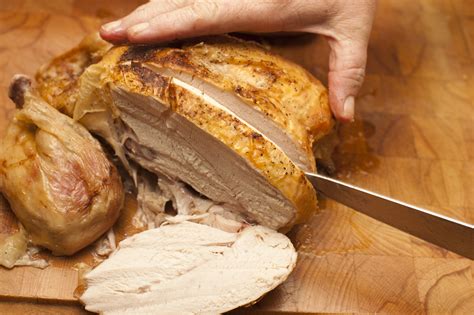 Cutting Roasted Chicken With Knife Free Stock Image
