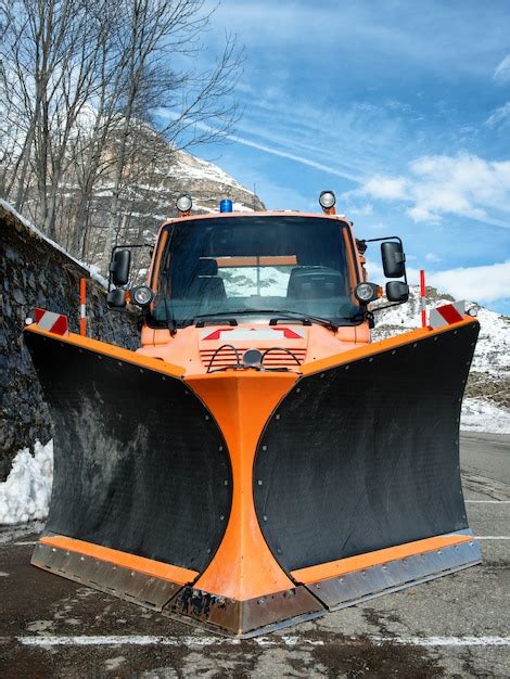 Premium Photo Small Orange Truck Using Snow Plow