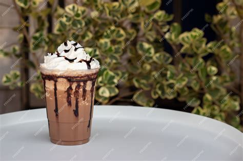 Premium Photo Mocha Frappe In Plastic Cup Served With Whipping Cream