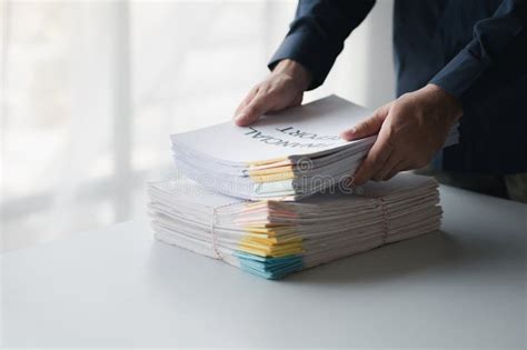 Businessman Sorting Stacks Of Department Meeting Papers Document