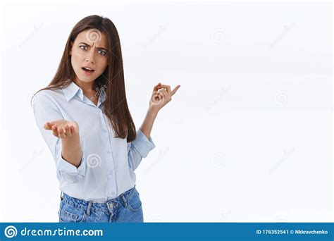 Irritated Young Businesswoman Pointing At Chart And Scolding Emplpoyee
