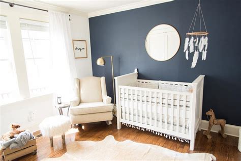 Baby boy nursery with dark blue accent wall and white crib Would really