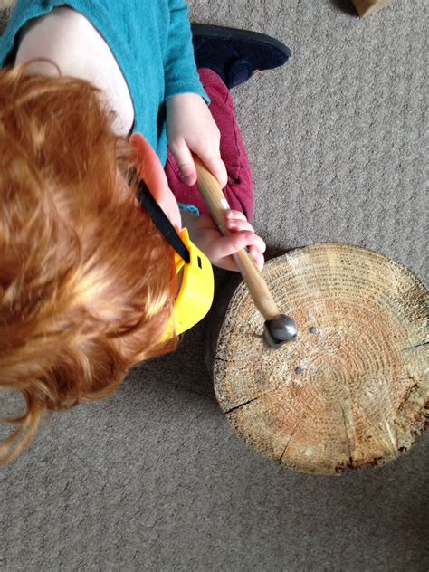Hammering Nails Into A Tree Stump Inside The Classroom Nail Designs