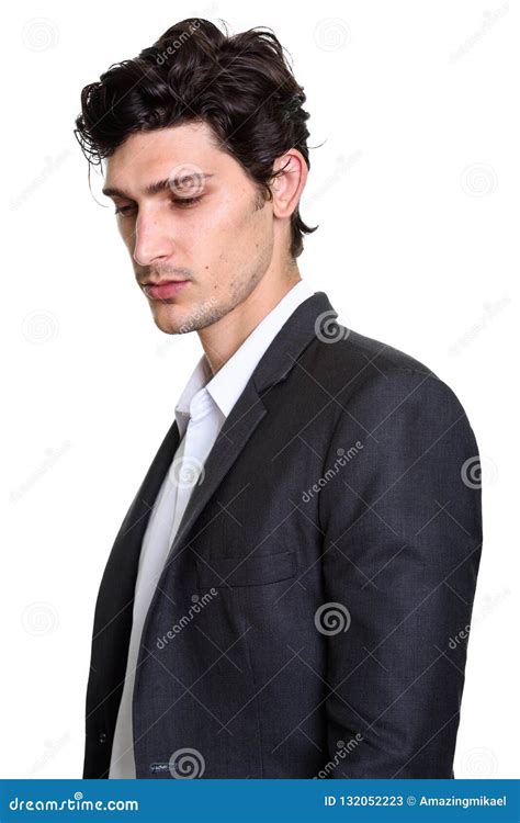Studio Shot Of Young Handsome Businessman Looking Down Stock Image