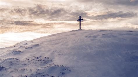 Cross On Top Of White Snow Covered Moutain Under White Sky