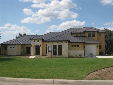 Farmhouse exterior home with a metal roof ideas. Dark Bronze Metal Roofs