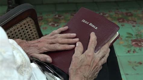 Senior Elder Woman Praying With Hands Clasped Over The Bible Elderly Woman In Her Daily