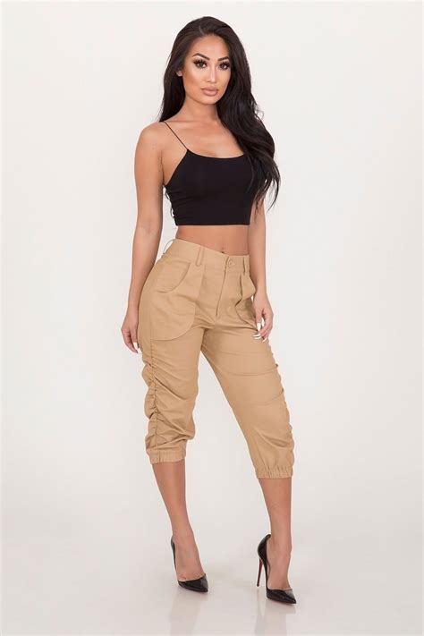 A Pair Of Cargo Style Joggers Featuring A Drawstring Waist Side Flap Pockets And Capri Legs