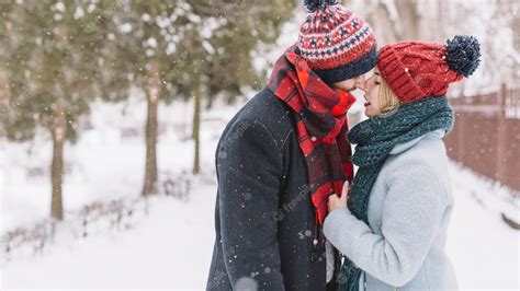 Free Photo Trendy Loving Couple Kissing In Snowfall
