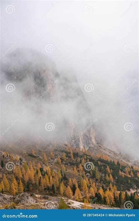 Dolomite Mountain Peaks Covered In Fog At Sunrise Autumn Season