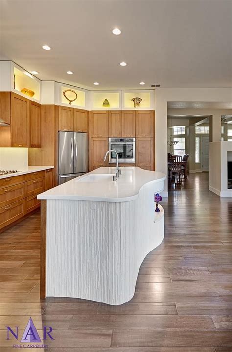This Curved Countertop Adds An Unique Touch To This Kitchen Design By