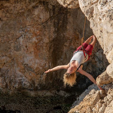 Woman Hanging From Cliff Stock Photos Pictures And Royalty Free Images