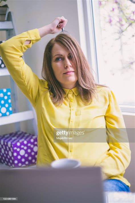 Pretty Girl Sitting At Desk In Bright Office High Res Stock Photo