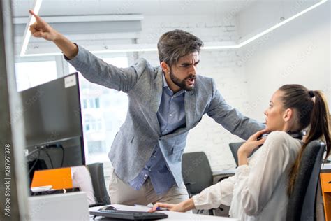 Angry Boss Firing Upset Female Employee In Office Young Male Business