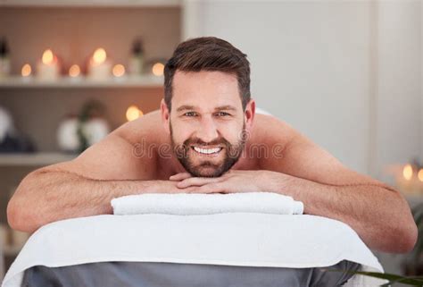 portrait handsome caucasian man lying on a table at the spa for his back massage shirtless man