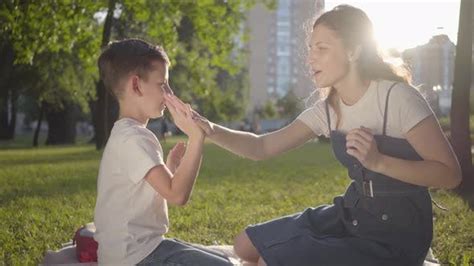 Older Sister Spending Time With Younger Brother Outdoors Stock Footage