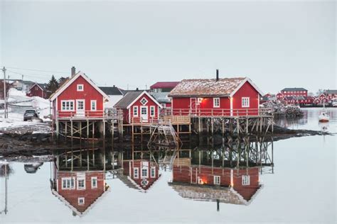 Scandinavian Village With Red House Reflection On Arctic Ocean Stock