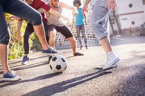 Friends Playing Soccer In Summer Street Stock Image F0180379