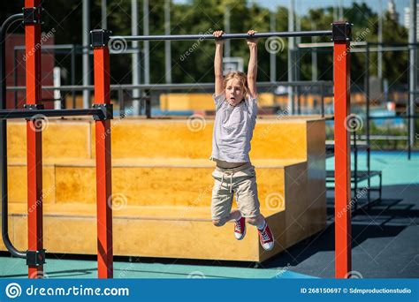 Boy Hanging From The Pull Up Bar Outdoors Stock Image Image Of
