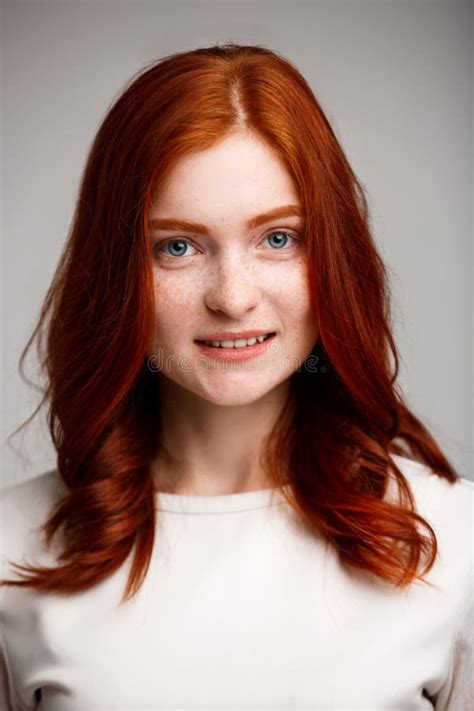 Portrait Of Young Beautiful Ginger Girl Over Gray Background Stock