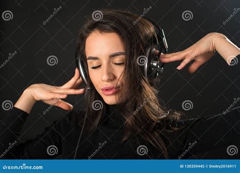 Close Up Portrait Of Young Beautiful Brunette Woman Listening To Music