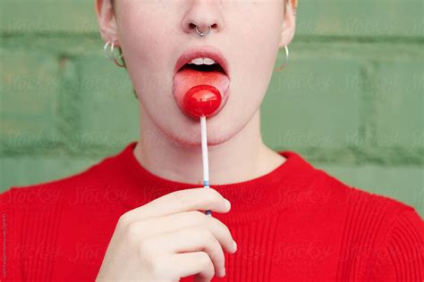 Alluring Woman Licking Lollipop By Stocksy Contributor Guille Faingold Stocksy
