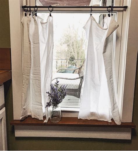 White cafe curtains are incredibly hard to photograph when you don't really know how to use your camera on the manual setting. Super easy clip ring, tension rod, and flour sack curtains ...
