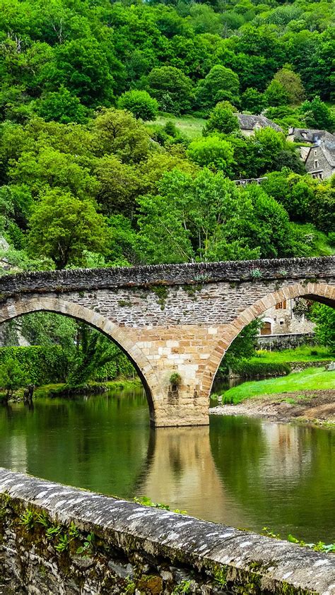 Belcastel Medieval Stone Bridge Across Aveyron River With Forest