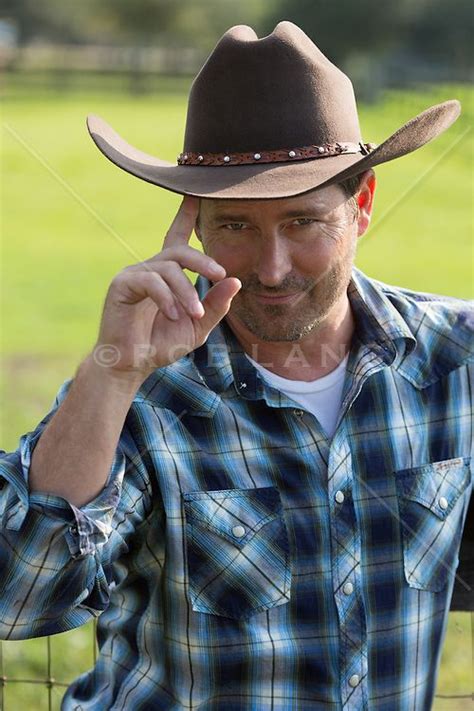 Portrait Of A Handsome Cowboy Outdoors Tipping His Cowboy Hat Cowboy