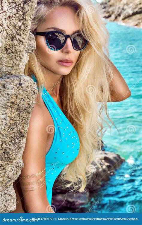 Beautiful Stunning Blonde Woman In Sunglasses And Elegant Clothes And Bikini Around The Pool