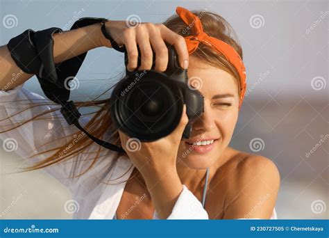 Photographer Taking Photo With Professional Camera Near Sea Stock Image