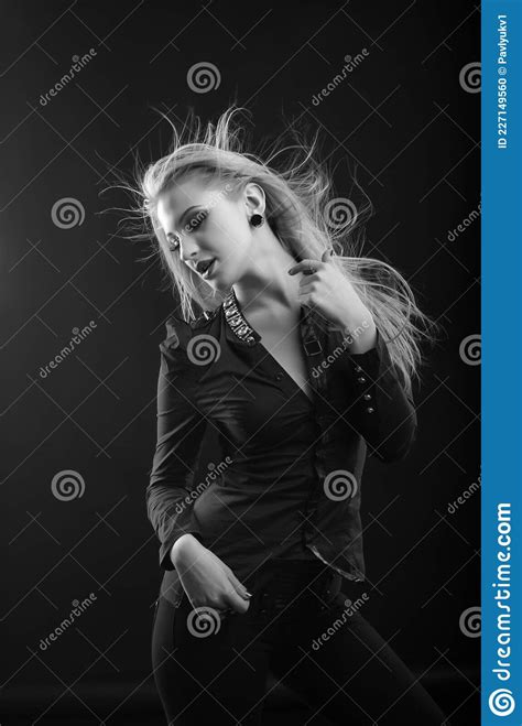 Passionate Blond Woman With Long Fluttering Hair Posing At Studio Stock