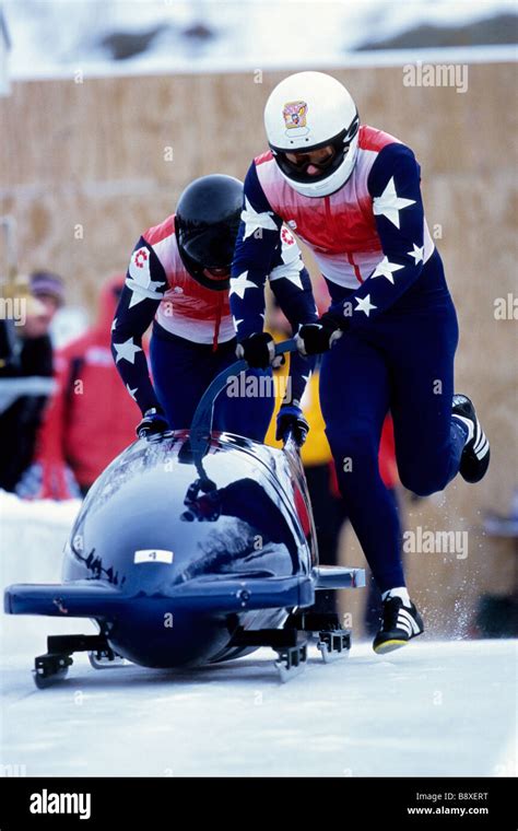 Two Man Bobsled Team Pushing Off At The Start Stock Photo Alamy