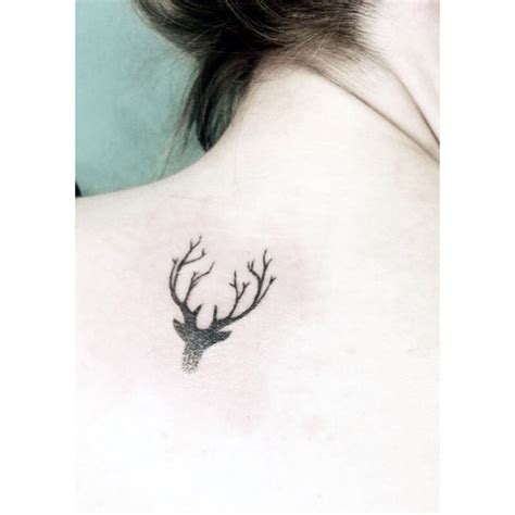 The Back Of A Womans Shoulder With A Deer Head Tattoo On Her Chest