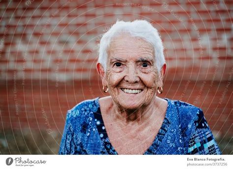 Portrait Of Old Lady In Her S Laughing Happily A Royalty Free Stock Photo From Photocase