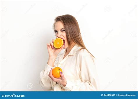 Young Caucasian Pretty Cunning Brunette Woman Biting One Orange Half