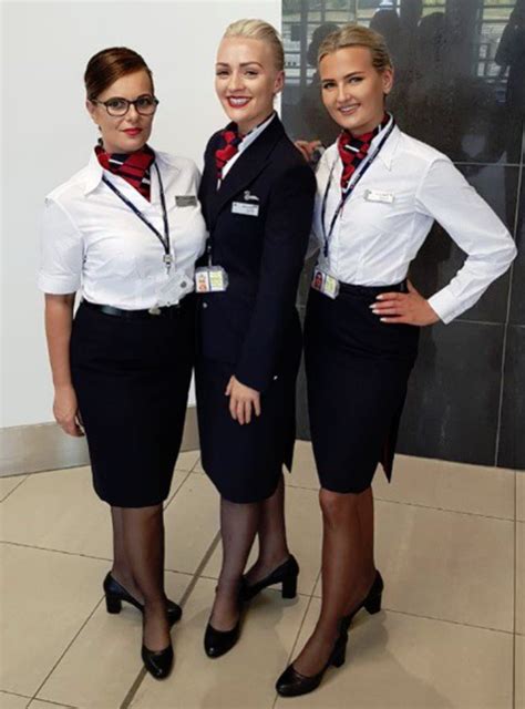 Three Air Hostess Standing Next To Each Other