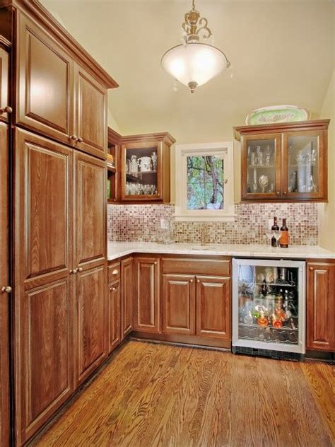 If your space is oddly shaped, you may need some custom cabinets (to fit odd corners. like Wood stained cabinets with wood floors and white ...