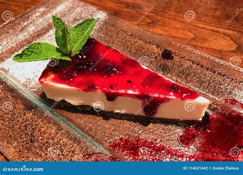 Slice Of Cheesecake With Cranberry Jam On Glass Plate Decorated With