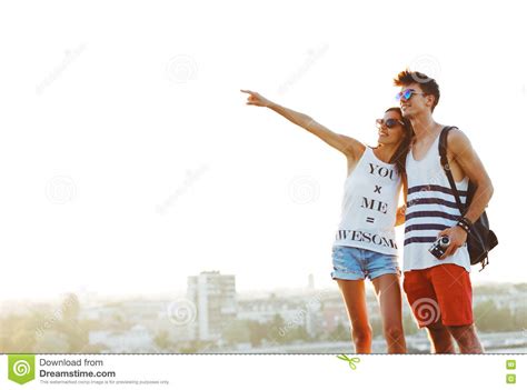 Two Young Tourists Sightseeing A Town Pointing With Finger Stock Image