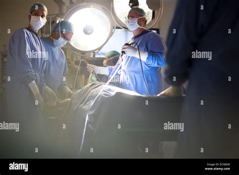 Team Of Doctors Performing Laparoscopic Surgery In Operating Theater
