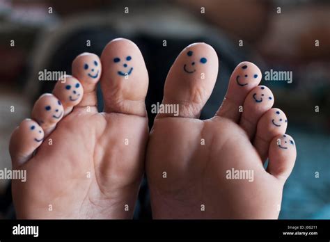 All Ten Toes Of Feet With Smiley Faces Drawn With Black Pen Stock Photo