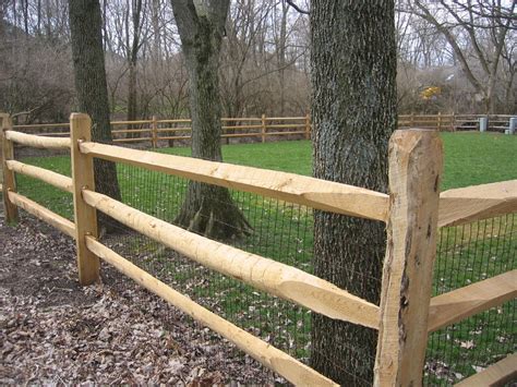 Split rail fences are constructed out of timber logs, typically split in half lengthwise to form the rails. Locust Split Rail Fence with wire mesh | Fence landscaping, Wood fence