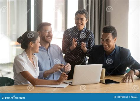 Happy Diverse Office Workers Team Laugh Work Together At Meeting Stock