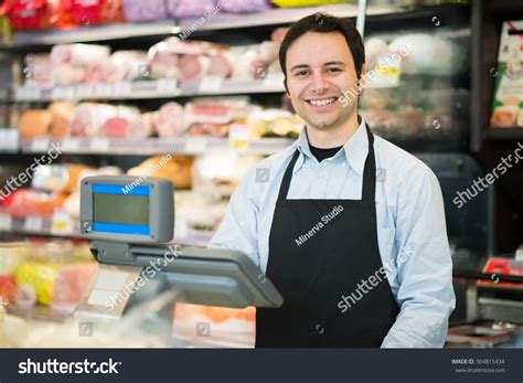 Portrait Of A Smiling Shopkeeper In A Grocery Store Stock Photo