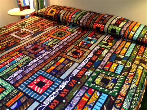 A Bed With A Colorful Quilt On Top Of It