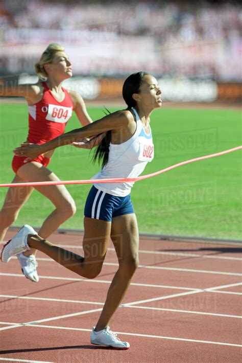 Female Runner Crossing Finish Line Stock Photo Dissolve