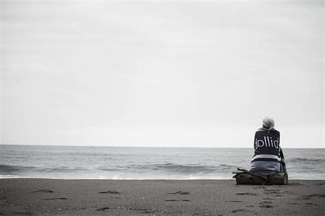 Woman Sitting Near Seashore During Daytime Hd Wallpaper Peakpx